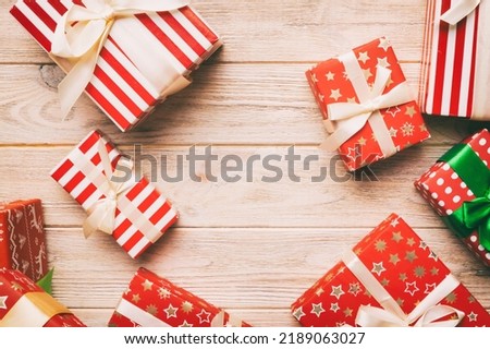 A lot of Christmas gift boxes in colored paper decorated on table, Top view close up. Many present New Year gift.