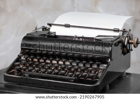 Vintage old typewriter at desk table. Writer or screenwriter creative concept
