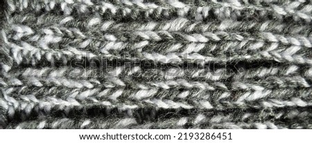 Pattern fabric made of wool. Handmade knitted fabric grey wool background texture