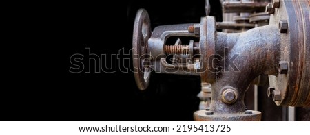 Industrial, machine scene. Steel, rusty valve and bolts on a dark background. Banner Copy space
