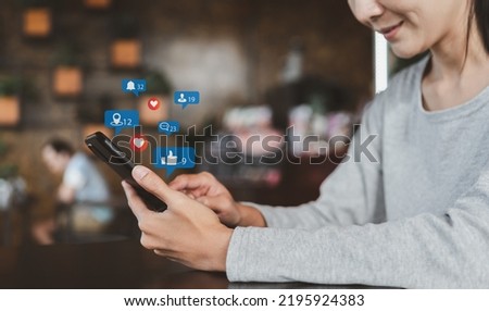 Social media and digital network concept online. Woman using smartphones in a coffee shop.