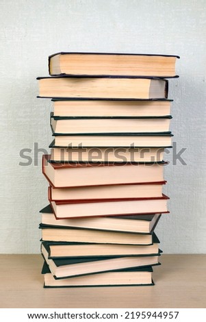 A stack of books on a shelf in a library. Concept reading, education, back to school