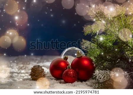 Christmas decorations on snow-covered boards with spruce twigs, cones, Christmas decorations. Copy space.