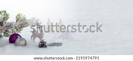 White and purple Christmas decorations in the snow. Christmas panoramic banner