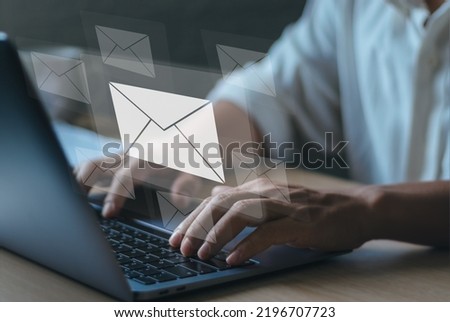 concept of technology the modern Internet responds to messages to customer e-mails. Man's hand typing on laptop keyboard with envelope icon showing communication between buyer and seller.