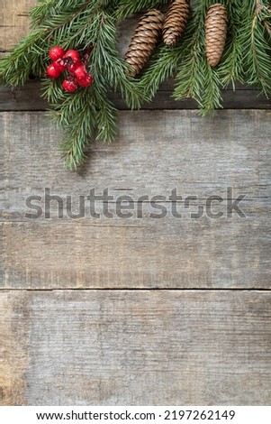 Vintage Christmas postcard design. Red Christmas decorations on a wooden background.