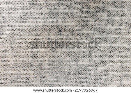 Grey knitted texture close-up, soft warm material