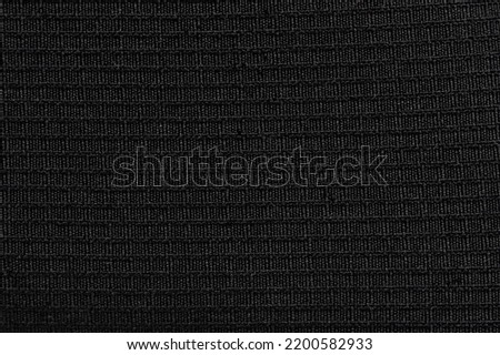 Black cloth material pattern texture with lines close up view