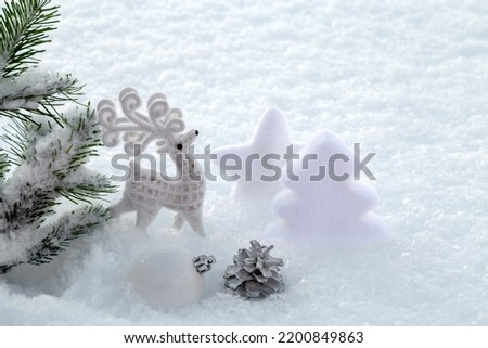White Christmas decorations in the snow. Copy space.