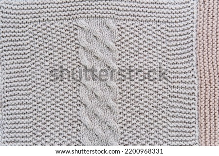 Texture of knitted pattern of gray wool in form of close-up vertical harness as abstract background