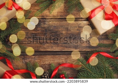 Frame made with gift boxes and Christmas decor on wooden table, flat lay. Space for text