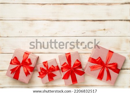 Gift boxes on wooden background, top view.