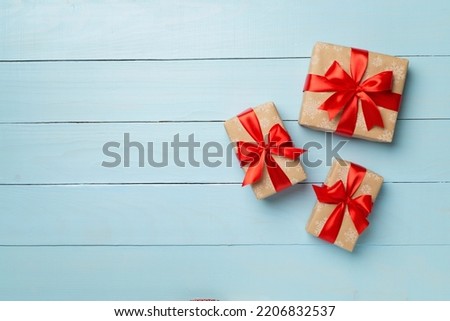 Gift boxes on wooden background, top view.