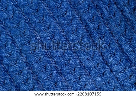 Woolen background with a blue braided pattern