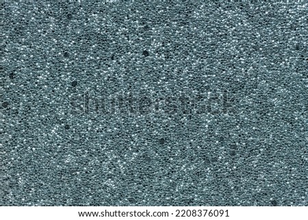 Luxury metallic blue background. Abstract texture scales with metallic blue sequins close-up. Glamor background with shiny sequins on fabric, macro.