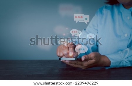 Women hand using smartphone typing Live chat chatting and social network concepts, chatting conversation working at home in chat box icons pop up. Social media marketing technology copy space concept.