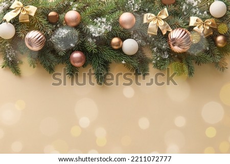 Beautiful Christmas tree branches with decor on beige background with space for text