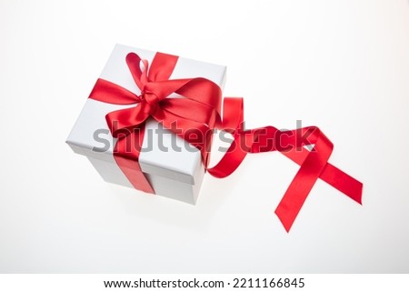 Gift box red ribbon and bow isolated on white background, Christmas Valentine day present, satin curly decoration