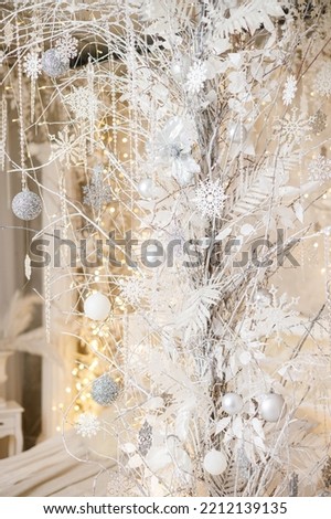 The interior of the house is decorated with a Christmas tree in anticipation of the holiday. A large bright room is decorated with decorations. New Year. Christmas decorations