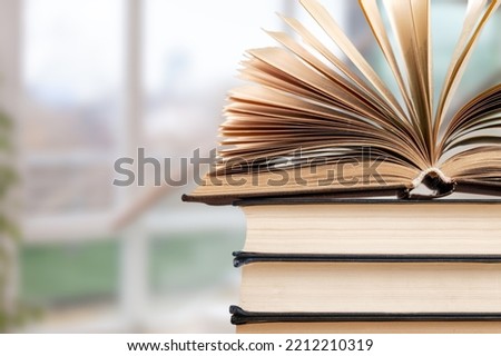 Reading book stack on blur interior