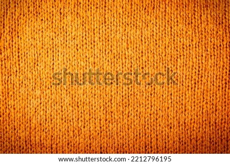Autumn concept - background of knitted woolen brown sweater. Knit fabric texture. Close up view. Knit background