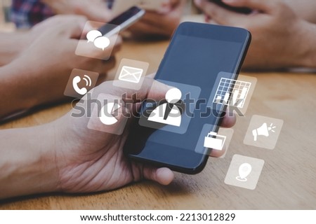 people hand using mobile smart phone with virtual social media icon diagram, mobile application, contact us, digital marketing, work from home, business finance, internet network technology concept