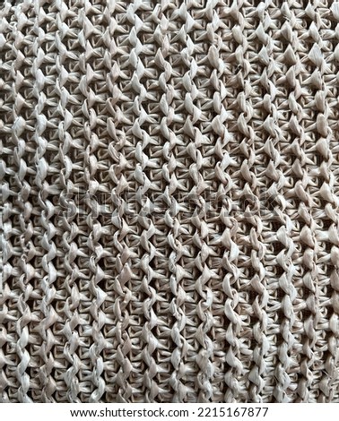 Close up of beige brown woven canvas mesh material used for a bag rucksack