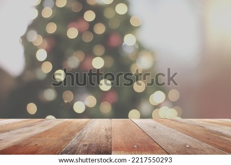 rustic wood table in front of christmas light night,abstract circular bokeh background