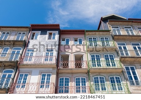 Oporto cityscape with colourful facades of old balconies landmark on a blue sunny sky in Oporto, Portugal