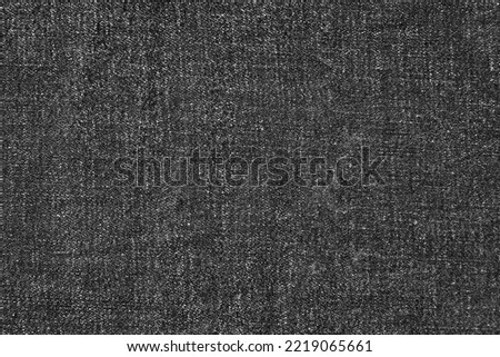 Background texture from black denim jeans cotton fabric. Top view with copy space.