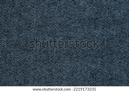 Navy blue denim fabric pattern close up as background