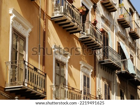 balcony rows on buinding yellow painted facade