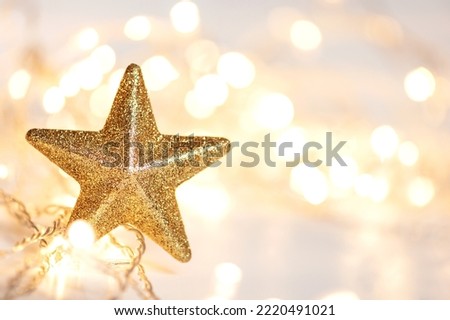Christmas lights and golden star with abstract defocused bokeh lights. copy space