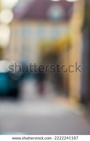 Blurred abstract city street background. People and cars in bokeh, abstract background image of a city street in bokeh, vertical orientation