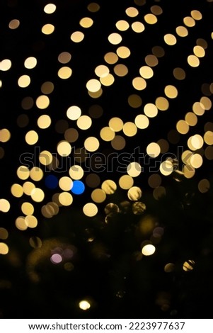 defocused christmas garlands of glowing yellow light bulbs. Abstract festive background, bokeh