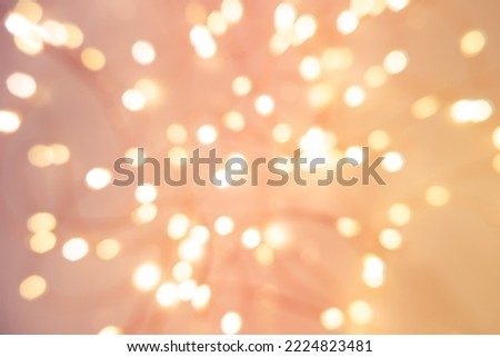 Defocused abstract Christmas background with garland pink light. High quality photo