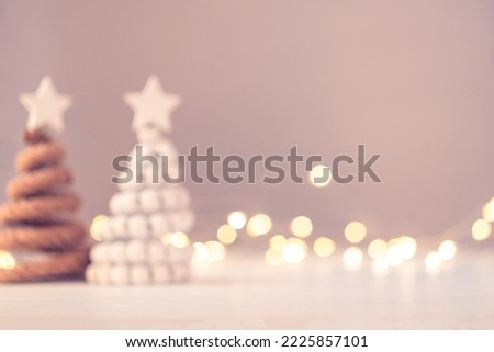 Christmas trees on table with bokeh lights. Defocused image for background.