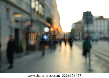 Blurred view of people walking on city street