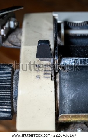 Photo of part of an old white manual typewriter.