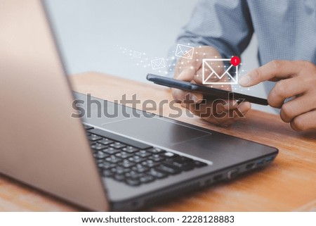 close up of a man's hand holding smartphone and checking email online on the web with virtual interface technology concept