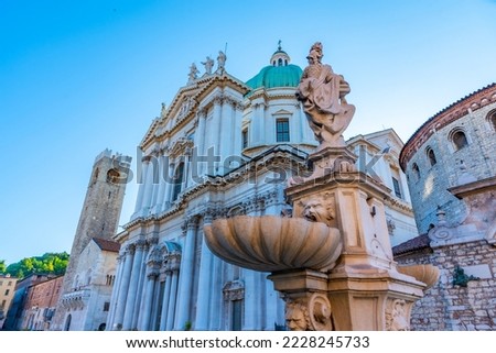 Cathedral of Santa Maria Assunta behind a fountain in Brescia, Italy