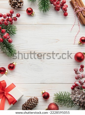 Christmas decoration with presents making a frame on a white wooden background. Christmas themes. Flat lay, copy space