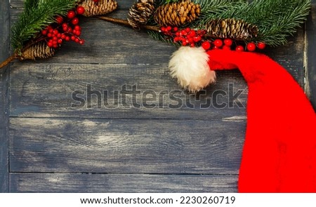 Christmas wooden background with fir branches and congratulations with a place to copy.