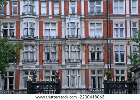 Elegant apartment bulding, red brick with stone trim around bay windows