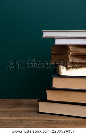 Stack books in front of the blackboard