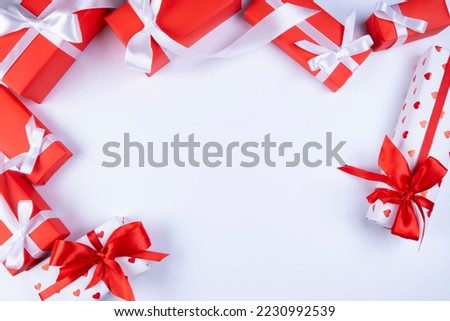 background or frame with place to insert text with red festive boxes with ribbons and bows or gifts on white background, new year, christmas or holidays concept. 