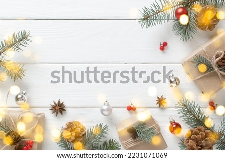 A Christmas gift wrapped in kraft paper and decorated with natural materials, on a white wooden table with a festive bokeh.