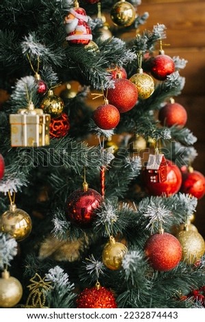 Christmas tree decorated with red and gold balls and toys