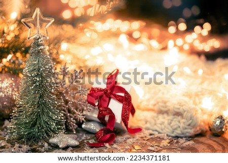 Christmas composition with a decorative tree and a gift box.
