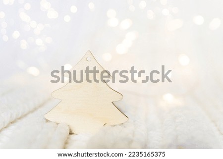 Wooden Christmas tree for your text on a white knitted background	